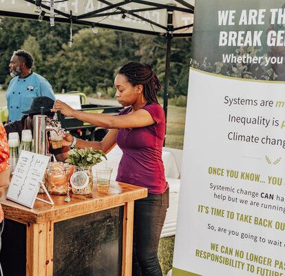 A custom 10x10 canopy tent is used as a mobile bar at the event. 