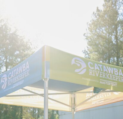 A custom 5x5 tent with printed graphics created for Catawba Riverkeeper. 