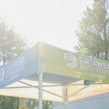 A custom 5x5 tent with printed graphics created for Catawba Riverkeeper. 