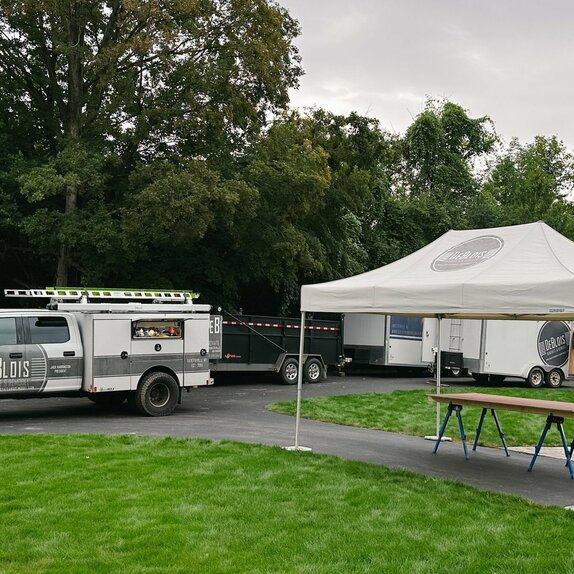 DeBlois Renovation and Remodeling truck and Mastertent set up outside worksite.