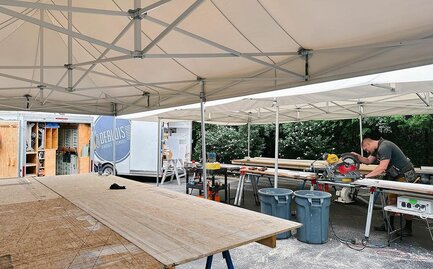 Carpenter working under Mastertent canopy on a job site