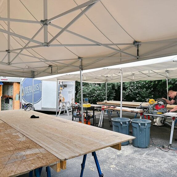 Carpenter working under Mastertent canopy on a job site