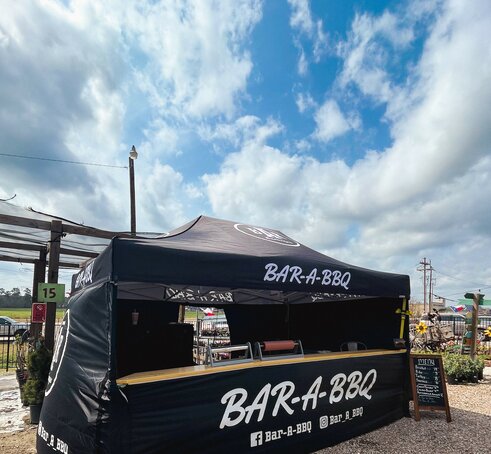 A black, 15x10 Mastertent canopy tent with wrap-around walls and serving counter. Branded for Bar-A-BBQ barbecue company.