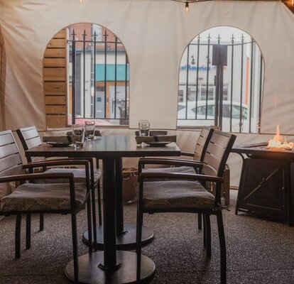 Mastertent ecru window sidewalls enclosing an outdoor dining space at Fig & Ash restaurant. 