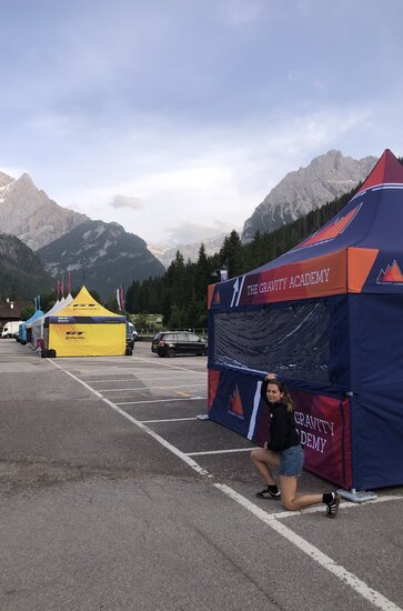 A printed 17x17ft canopy tent set up in a parking lot for a mountain biking event.