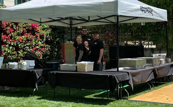 A 13x13 custom printed BBQ tent with a black tent frame and grey roof. 