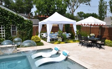 A white 13x13 backyard pool tent with corner curtains.