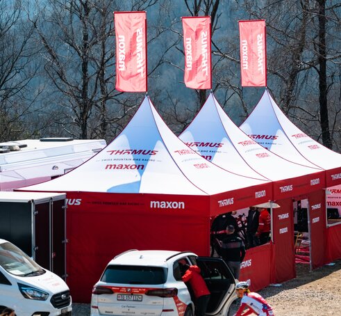 3 custom 17x17 mountain biking team tents with peak flags and custom sidewalls.   