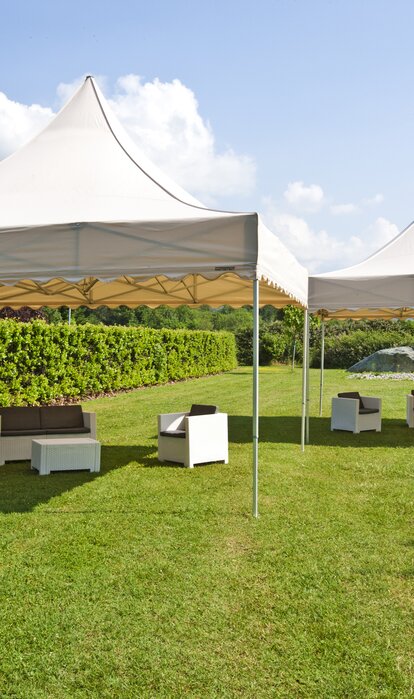 A 17x17 large event tents in Ecru for weddings and parties. Customized with a scalloped roof. 
