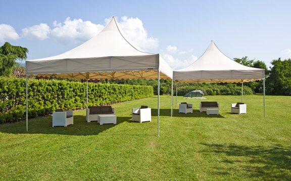 A 17x17 large event tents in Ecru for weddings and parties. Customized with a scalloped roof. 