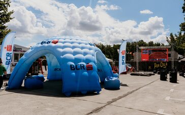 Large blue inflatable shelter at concert venue. 
