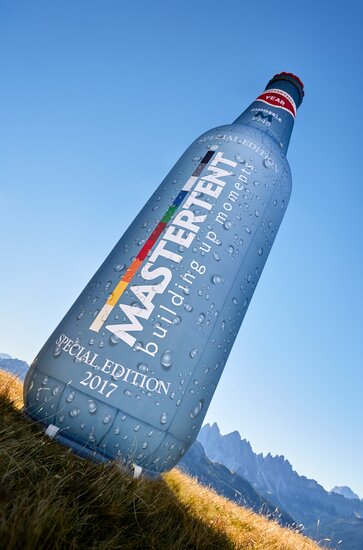 Mastertent branded bottle inflatable backlit on a field