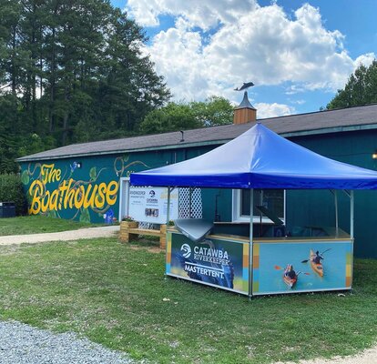 Catawba Riverkeeper pavilion set up in front of the boathouse. 