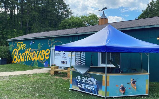 Catawba Riverkeeper pavilion set up in front of the boathouse. 