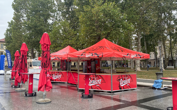 Red Union branded pavilions set up with matching umbrellas. 