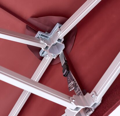 angled view of metal canopy tent framework with burgundy fabric