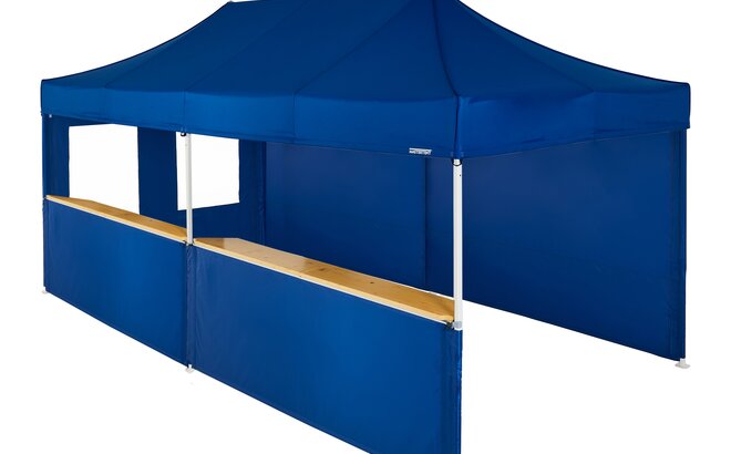 A blue 20x10ft Mastertent with five blue fabric sidewalls. Two sidewalls are closed, one is a window, and two are half-heights with wooden counters. 