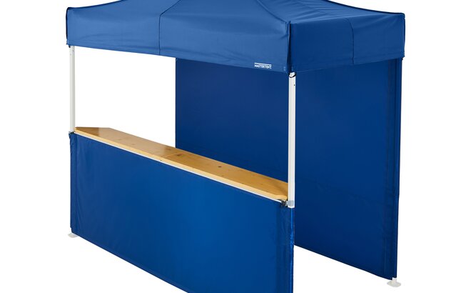 A blue 10x5ft Mastertent with two blue fabric sidewalls. One sidewall is closed and one is a half-height with a wooden counter. 