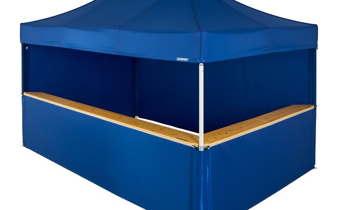 A blue 15x10ft Mastertent with four blue fabric sidewalls. Two sidewalls are closed and two are half-heights with wooden counters.
