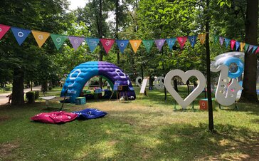 An inflatable tent is located at the Jazz in the Park Festival. It is colourful and big. It serves as a chill lounge and promotion corner. 