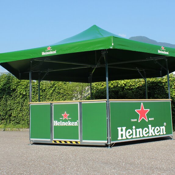 Green hexagon pavilion for Heineken. The beer pavilion is located on a square. 