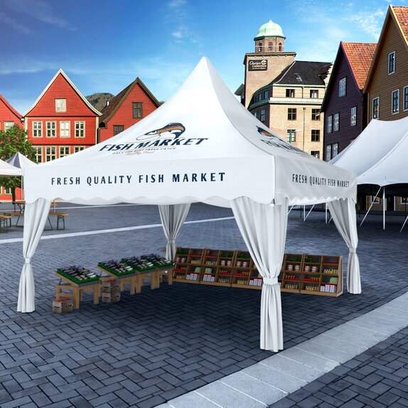 The white pagoda tent is located on the market square. Underneath the gazebo some boxes with fish from the sea are situated. In the background are some red buildings. 