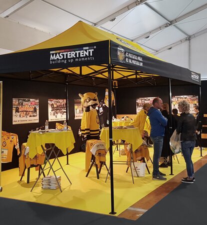 Canopy tent 6x3 for trade fair. Yellow and black tent customised with HC Pustertal team logo. 