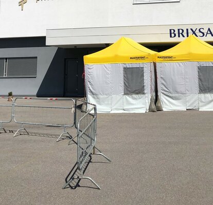 Pre-Triage Tent with a yellow roof in front of the private clinic Brixana.