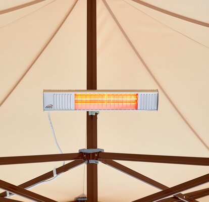 A mobile infrared heater mounted on the mast of a Mastertent canopy tent.