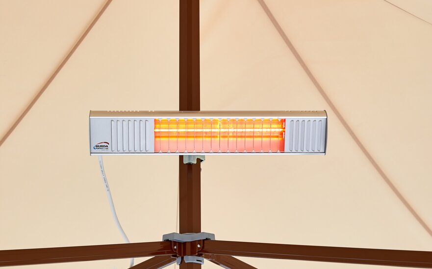 A mobile infrared heater mounted on the mast of a Mastertent canopy tent.