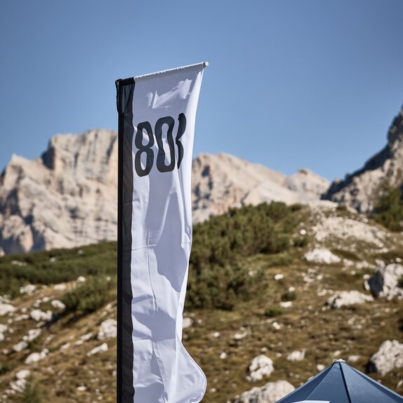 A white and black peak flag on a canopy tent printed with the number 803.