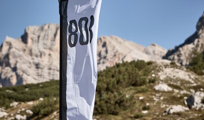 A white and black peak flag on a canopy tent printed with the number 803.